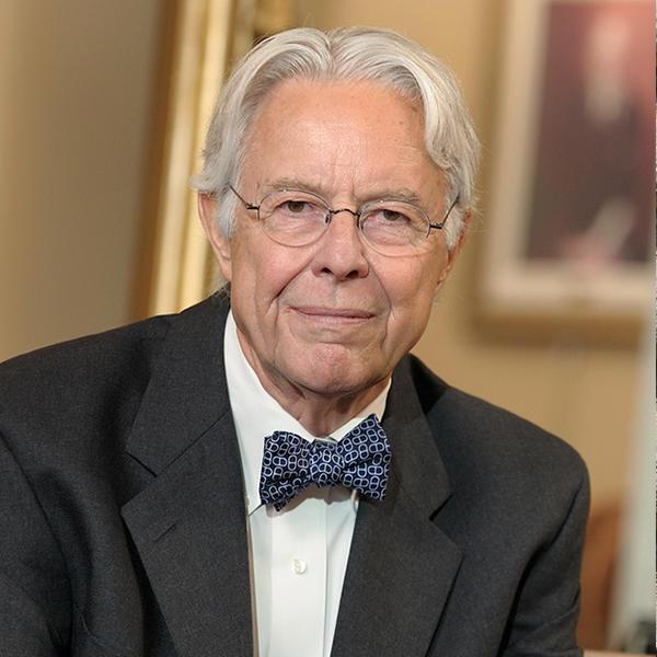 an older man with glasses and a bow tie